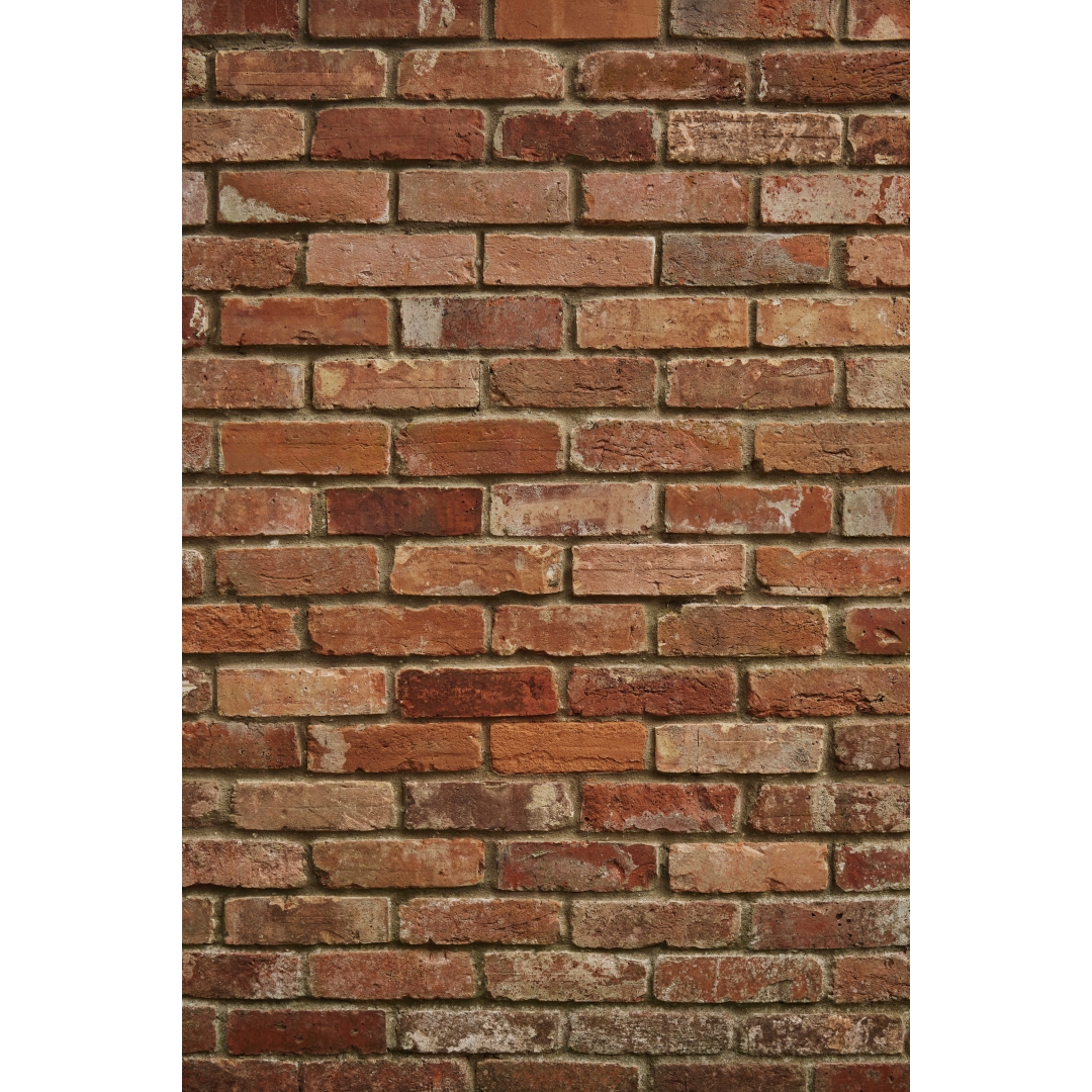 Fondo de ladrillo visto en tonos rojizos y tierra con acabado rústico tipo pared